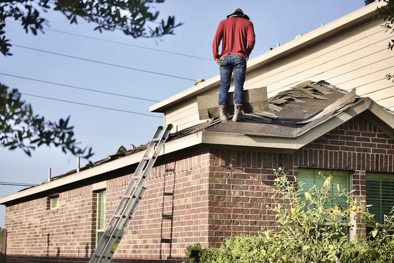 Professional roofer working on a residential roof in Helotes